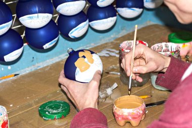 Noel süslemeleri fabrikası. Noel balosu üretimi, Noel oyuncakları fabrikasındaki üretim sürecinde basılı bir deseni olan cam Noel topları.