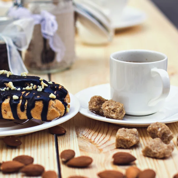 Pastel de chocolate (eclair) con taza de café —  Fotos de Stock