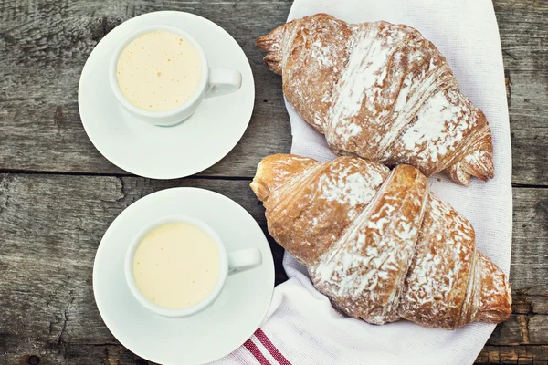 Two cup of coffee "espresso" and croissants on the wooden table. — Stock Photo, Image