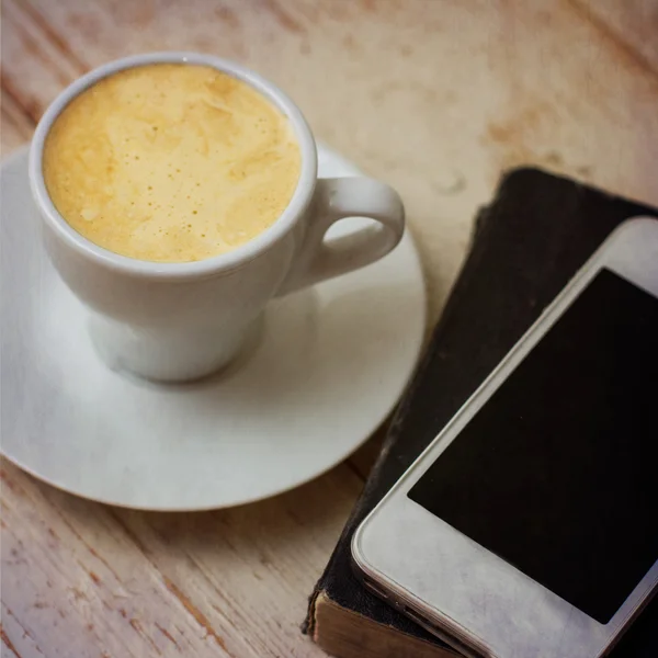 A cup of coffee "espresso", macaroon and a telephone. — Stock Photo, Image