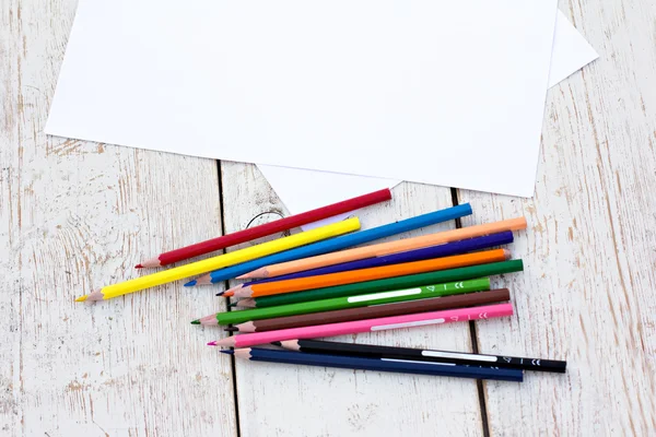 Renkli kalemler ve kağıt üstünde okul sırası — Stok fotoğraf