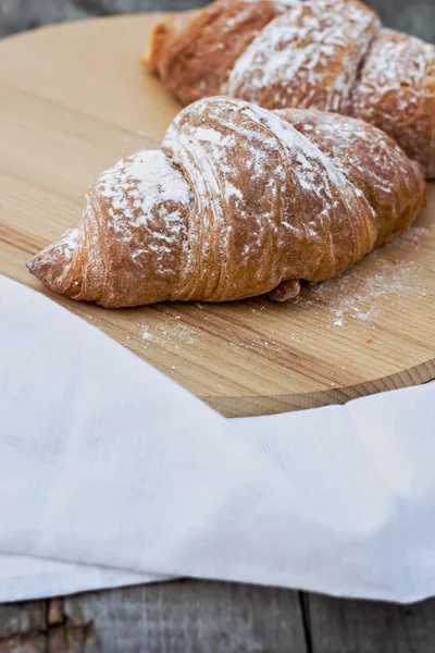 Two Croissants on the wooden table. — Stock Photo, Image