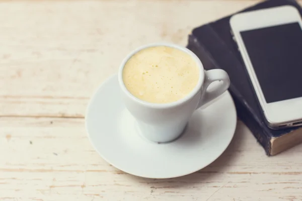 A cup of coffee "espresso", macaroon and a telephone. — Stock Photo, Image