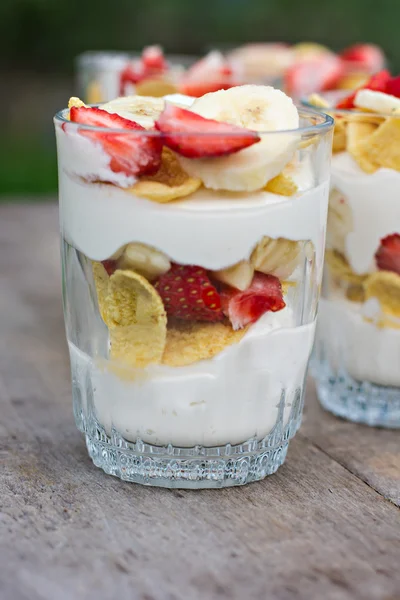 Breakfast - cheese, strawberry, banana, cornflakes on the table