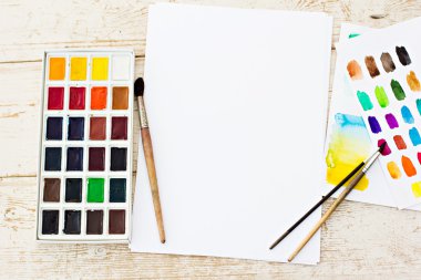 Workplace artist - paper, paint, brushes, color wheel. Mock up