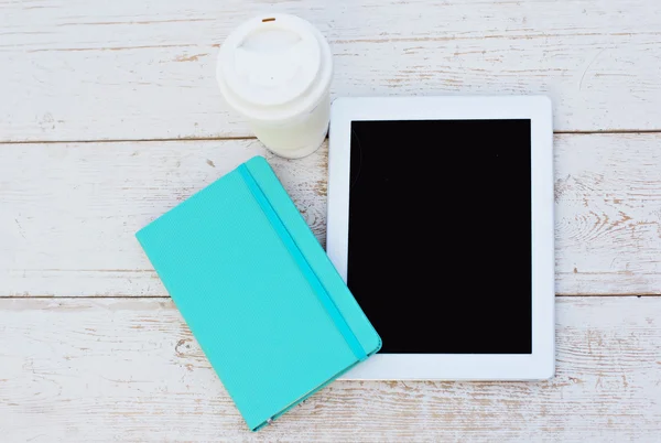 Diary, a tablet computerand  lilies of valley on the table — Stock Photo, Image