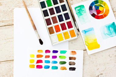 Workplace artist - paper, paint, brushes, color wheel. Mock up.