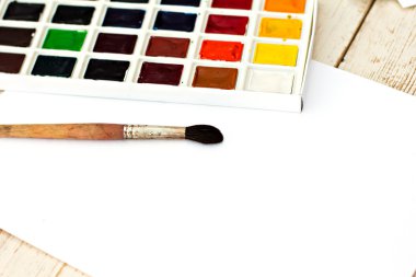 Workplace artist - paper, paint, brushes, color wheel. Mock up