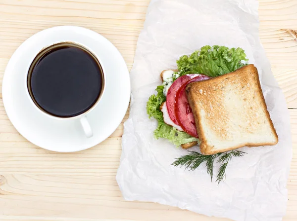 Sandwich and cup of black coffee on the table — Stock Photo, Image