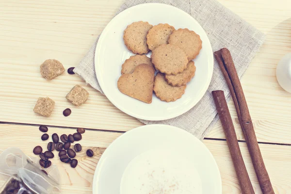 Biscoitos de gengibre, canela, um copo de café quente . — Fotografia de Stock