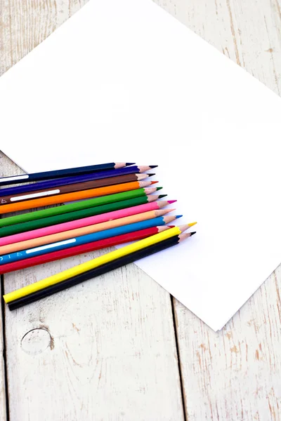 Colored pencils and paper — Stock Photo, Image