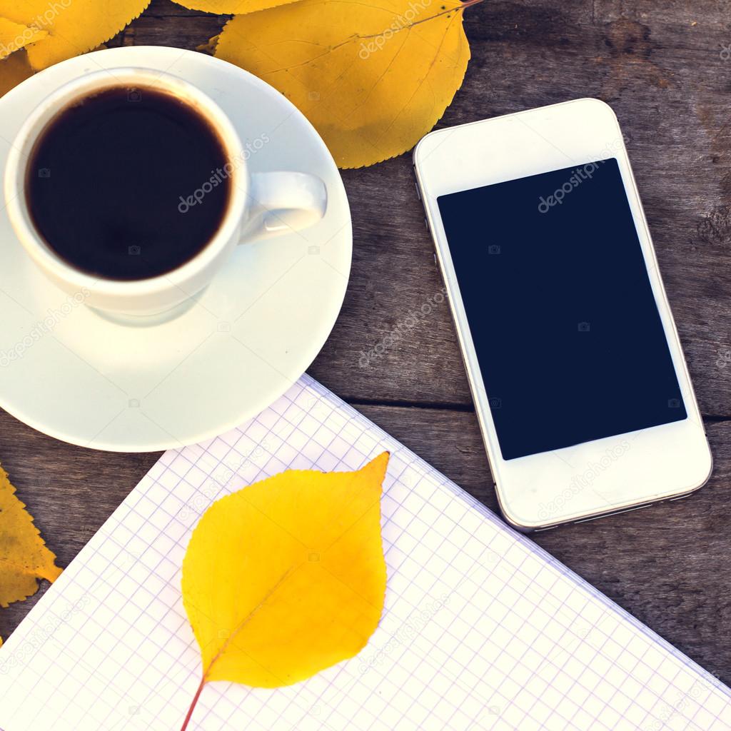 Notebook, mobile phone, cup of coffee