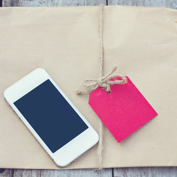 Gift in kraft paper — Stock Photo, Image