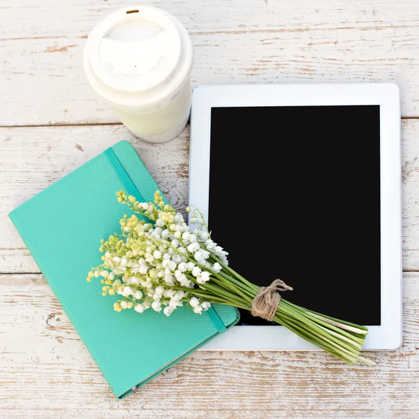 Diary, a tablet computerand  lilies of valley — Stock Photo, Image