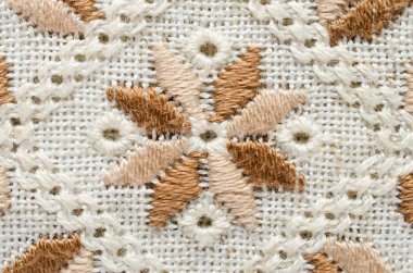 İşlemeli parçası keten pamuk iş parçacıkları tarafından üzerinde. Makro nakış doku düz dikiş.