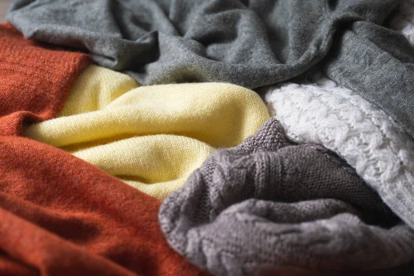 Fond d'automne aux couleurs chaudes avec une variété de pulls ou plaids tricotés en laine. — Photo