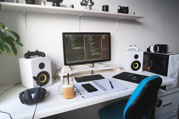 Empty modern developer workplace for writing code with computer desktop and comfy armchair