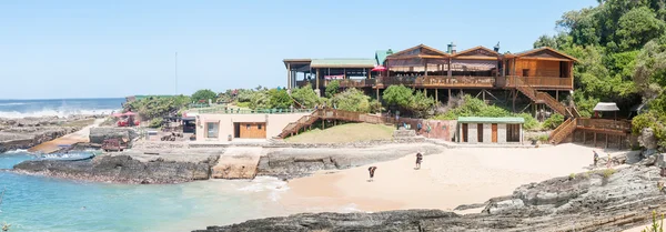 Restaurant, beach and small harbor — Stock Photo, Image