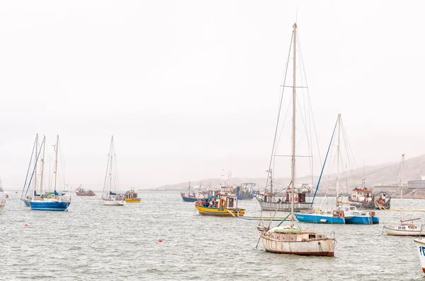 Boats in misty conditions at the harbor in Luderitz — Stock Photo, Image