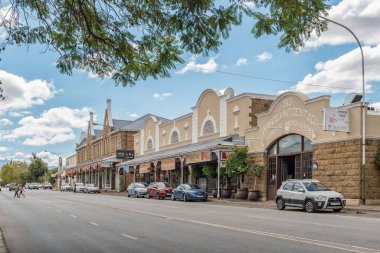 OUDTSHOORN, GÜNEY AFRİKA - 5 Nisan 2021: Batı Burnu Karoo 'daki Oudtshoorn' da iş, insan ve araçların olduğu bir sokak sahnesi.