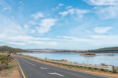 Batı Cape Eyaleti 'ndeki Theewaterskloof Barajı R45 yolundan görüldüğü gibi. Araçlar ve bir yol köprüsü görülebilir