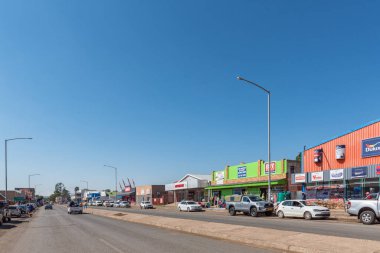 ALIWAL NORTH, Güney Afrika - 23 Nisan 2021, Aliwal North, Doğu Cape Eyaleti 'ndeki iş yerlerinin olduğu bir sokak sahnesi. İnsanlar ve araçlar görünür.