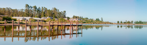 Early morning panorama of houses next to a dam 