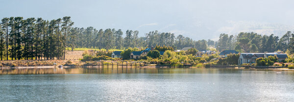 Early morning panorama of houses next to a dam 
