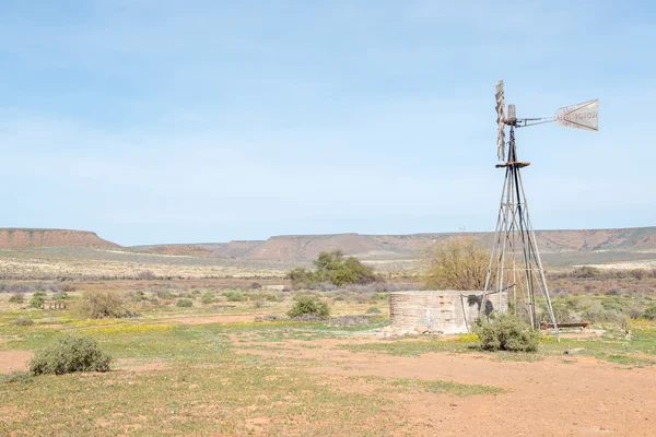 Typical farm scene with water pumping windmill and dam — Stock Photo, Image