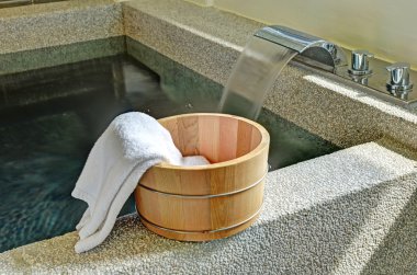 Bath bucket with a towel clipart