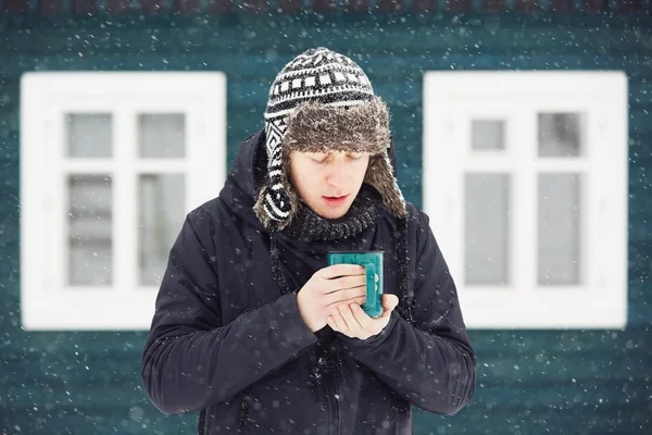 Young man in snowfall — Stock Photo, Image