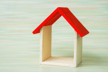 miniature house on wooden background, copy space.