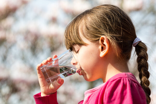 Girl drinking water from glass