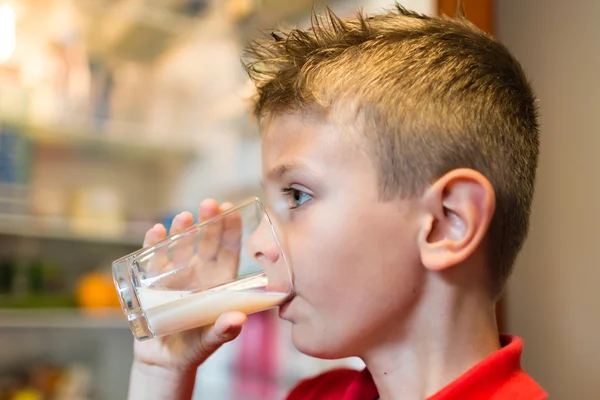 Boy drinking milk from glass — Stock Photo, Image