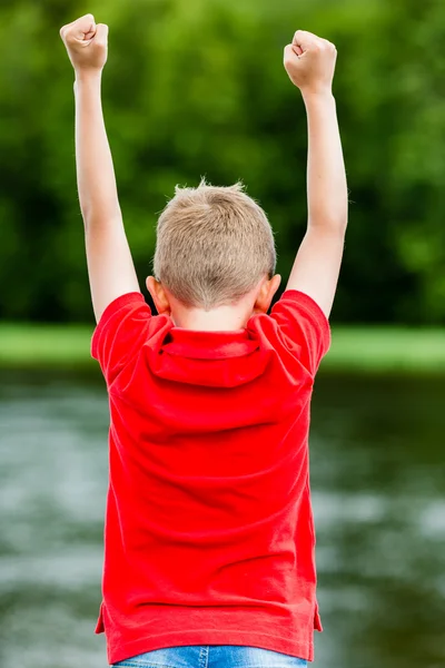 Child with raised fists — Stock Photo, Image