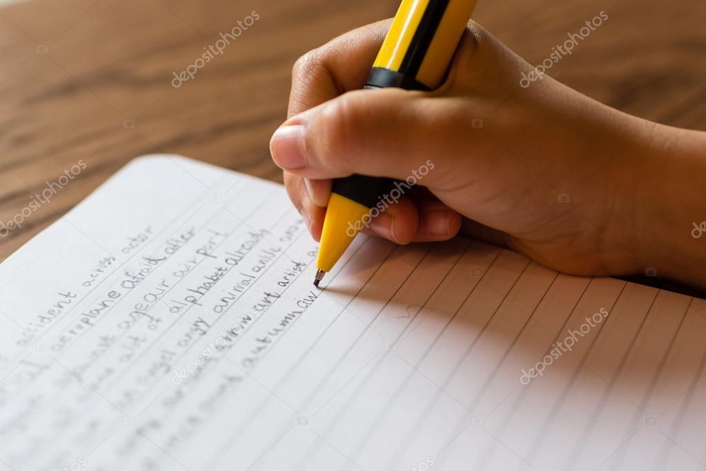 Person writing by hand on notepad Stock Photo by ©Bigandt 105049184