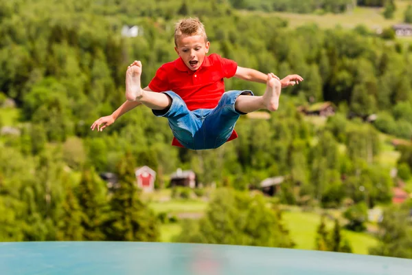 Young boy jumping on trampoline — Stock Photo, Image