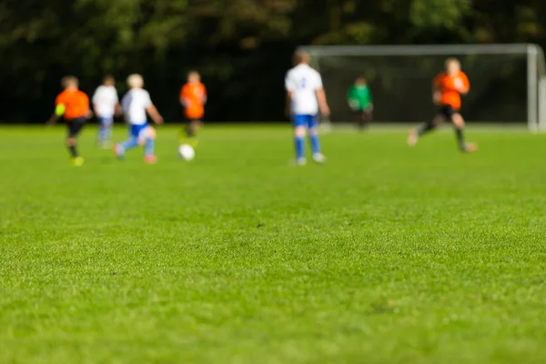 Blurred youth soccer players — Stock Photo, Image