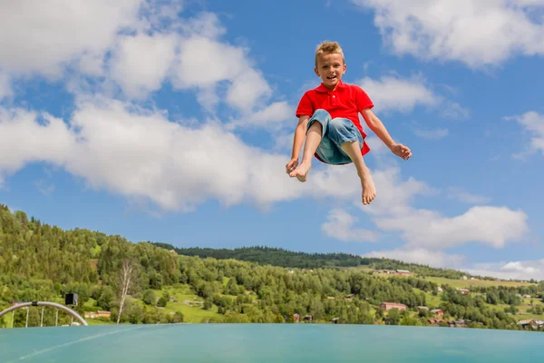 Child jumping on trampoline — Stock Photo, Image