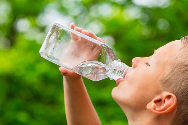 Junge trinkt Wasser aus Flasche — Stockfoto