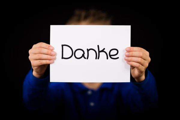 Child holding sign with German word Danke - Thank You — Stock Photo, Image