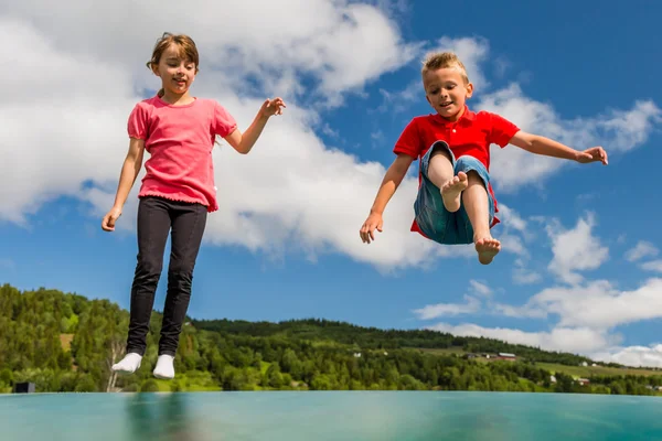 Barnen hoppar på studsmatta — Stockfoto