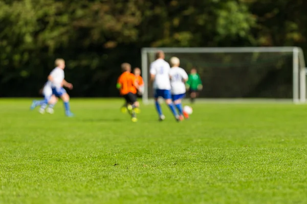 Blurred youth soccer players — Stock Photo, Image