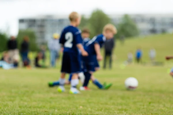 Три розмиті футбольні діти — стокове фото