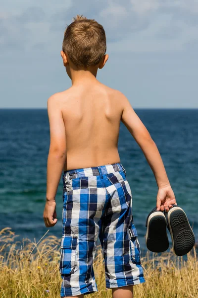 Boy with bathing shoes — Stock Photo, Image