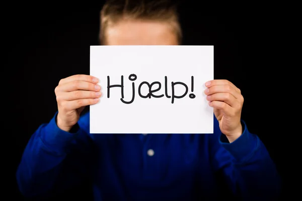 Child holding sign with Danish word Hjaelp - Help — Stock Photo, Image