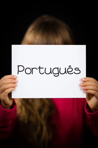 Child holding sign with Portuguese word Portugues - Portuguese i — Stock Photo, Image