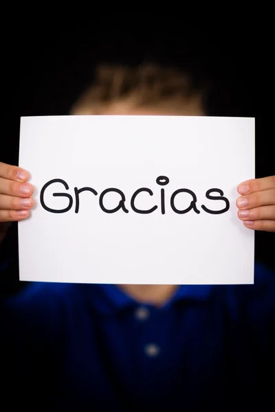 Child holding sign with Spanish word Gracias - Thank You — Stock Photo, Image