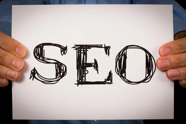 Person holding SEO sign — Stock Photo, Image