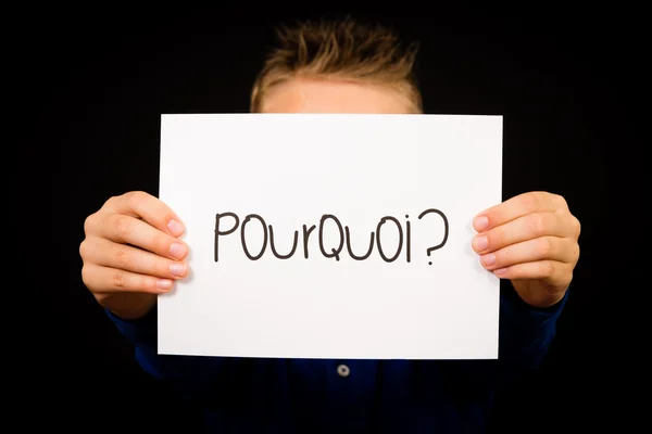 Child holding sign with French word Pourquoi - Why — Stock Photo, Image